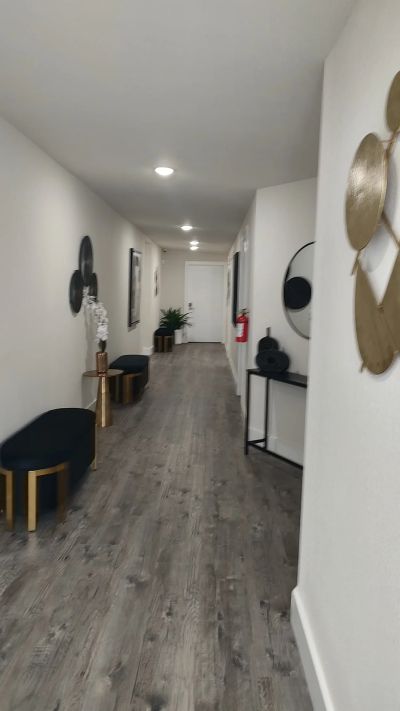 Hallway with mirror, ottoman, and console